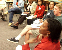 Photograph of people sitting in a cirlce